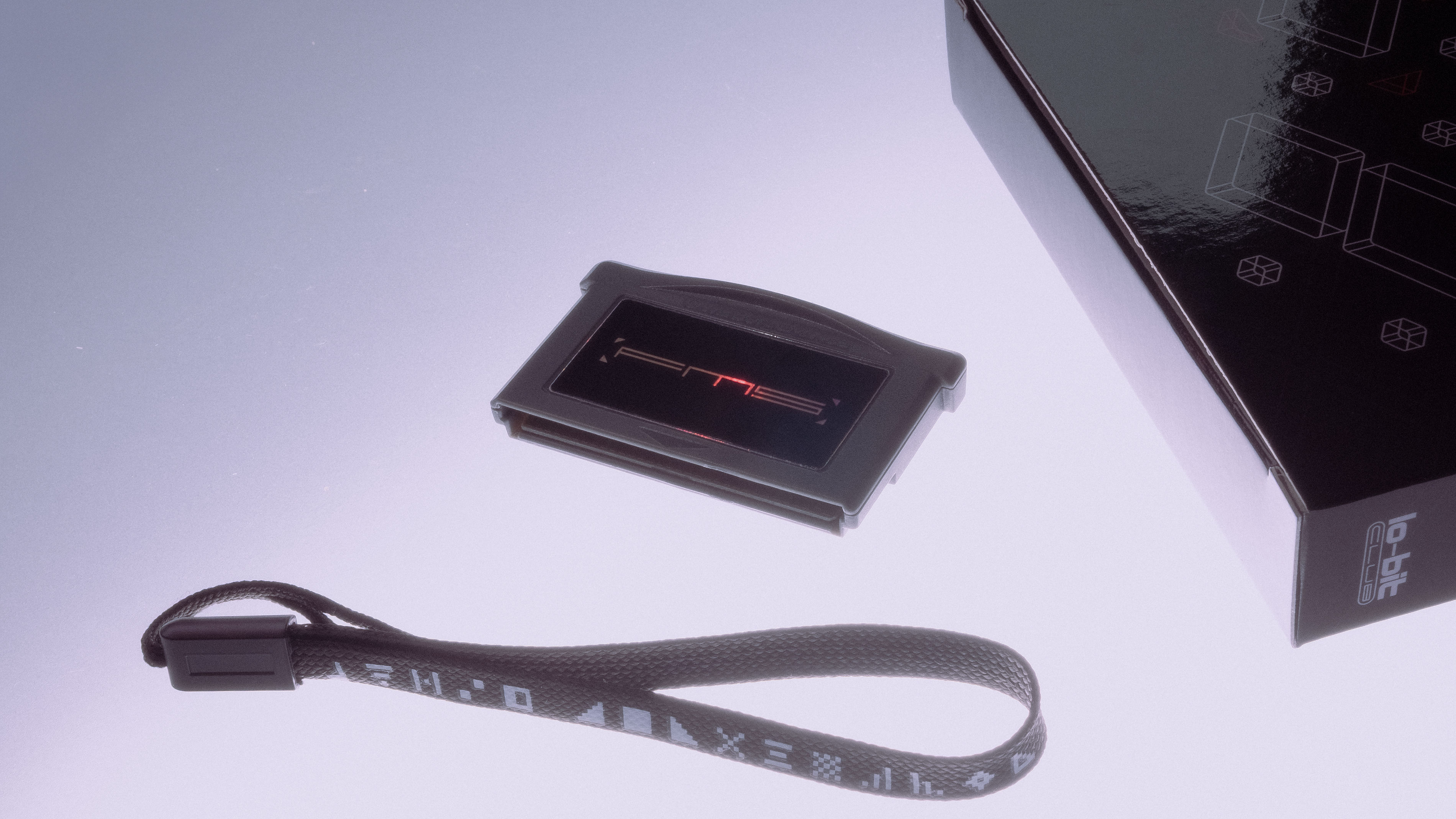 FMS cartridge, box and carrying strap laid onto a frosted glass lit from underneath